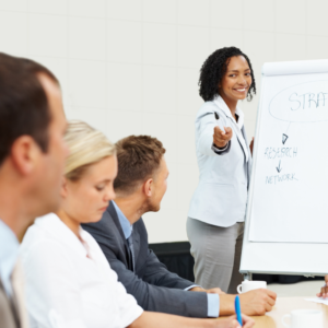 Woman Presenting to Group of Business People
