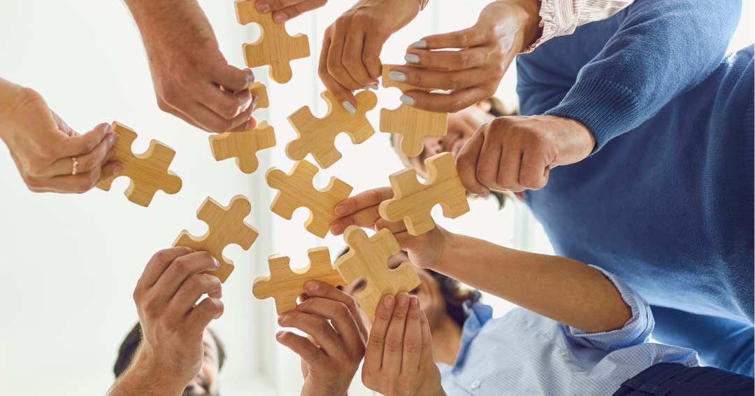 People putting together large puzzle pieces